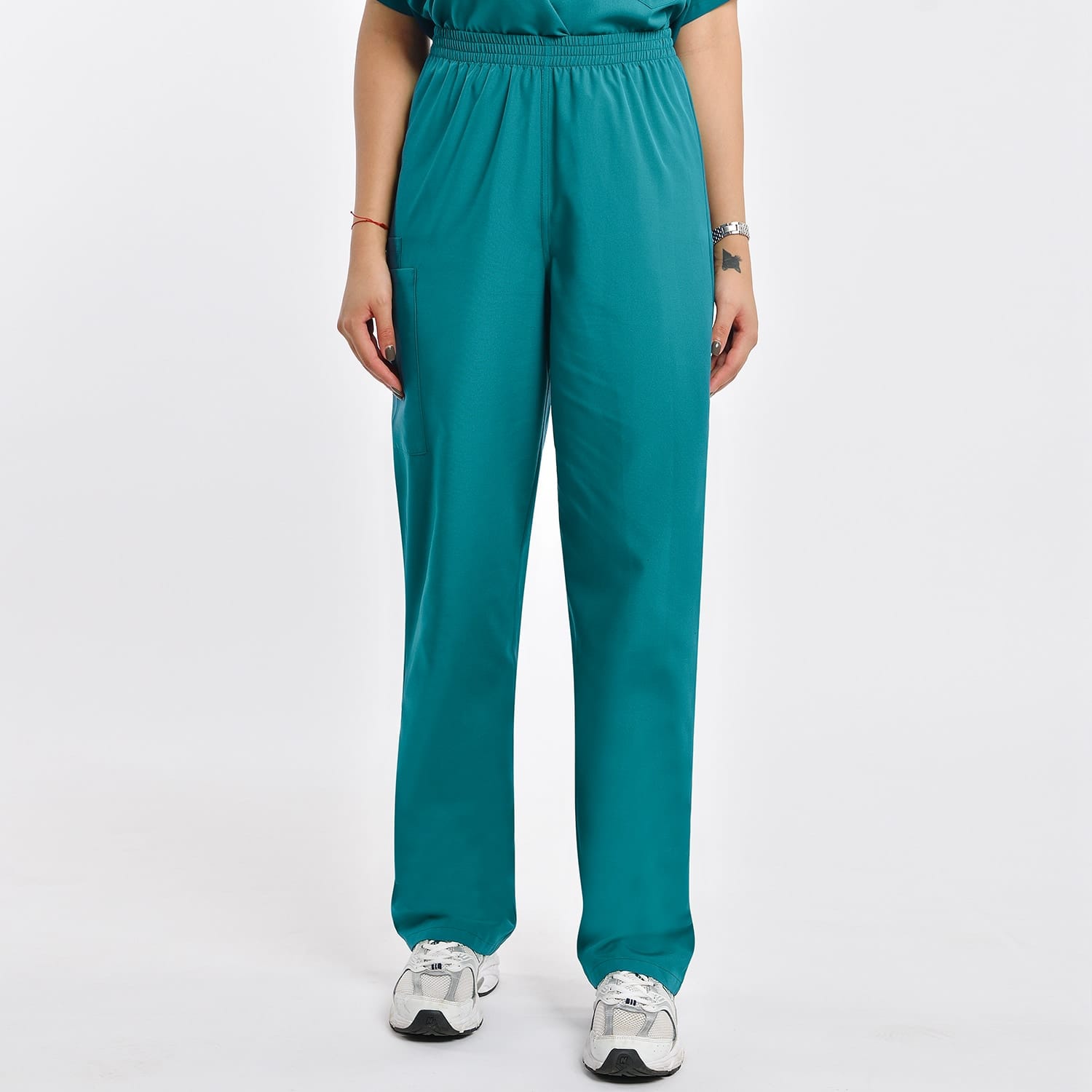 Teal scrub pants with elastic waistband and two pockets, durable for industrial laundry.