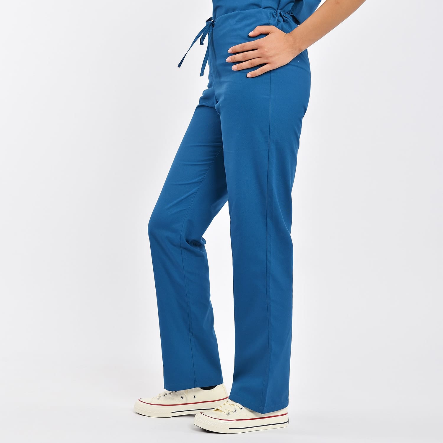 Side View of Medical Scrub Pants with Comfortable Fit and Functional Pockets Side view of unisex blue medical scrub pants with side pockets and adjustable waistband, ideal for healthcare professionals.