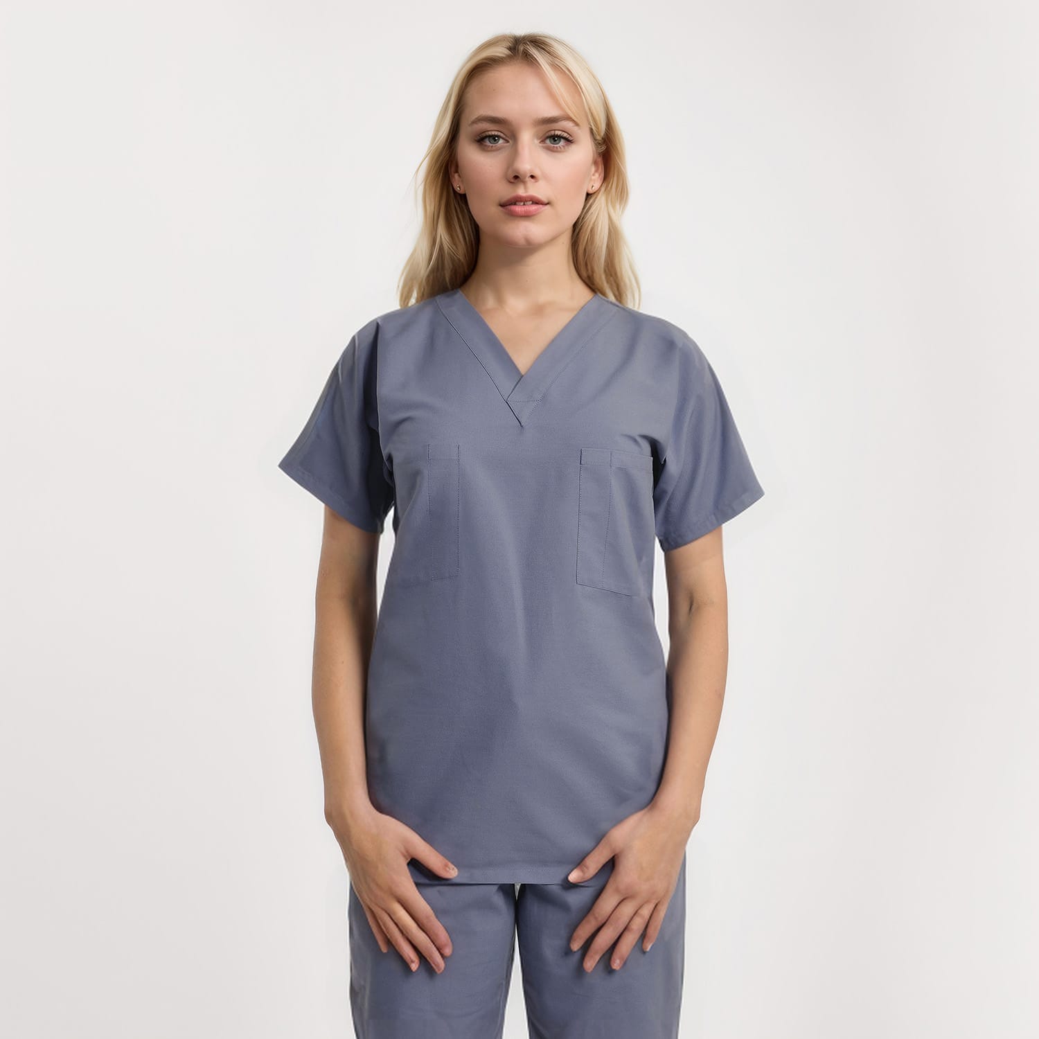 Front view of a model wearing a reversible V-neck scrub top in unisex style with one pocket, designed for healthcare workers.
