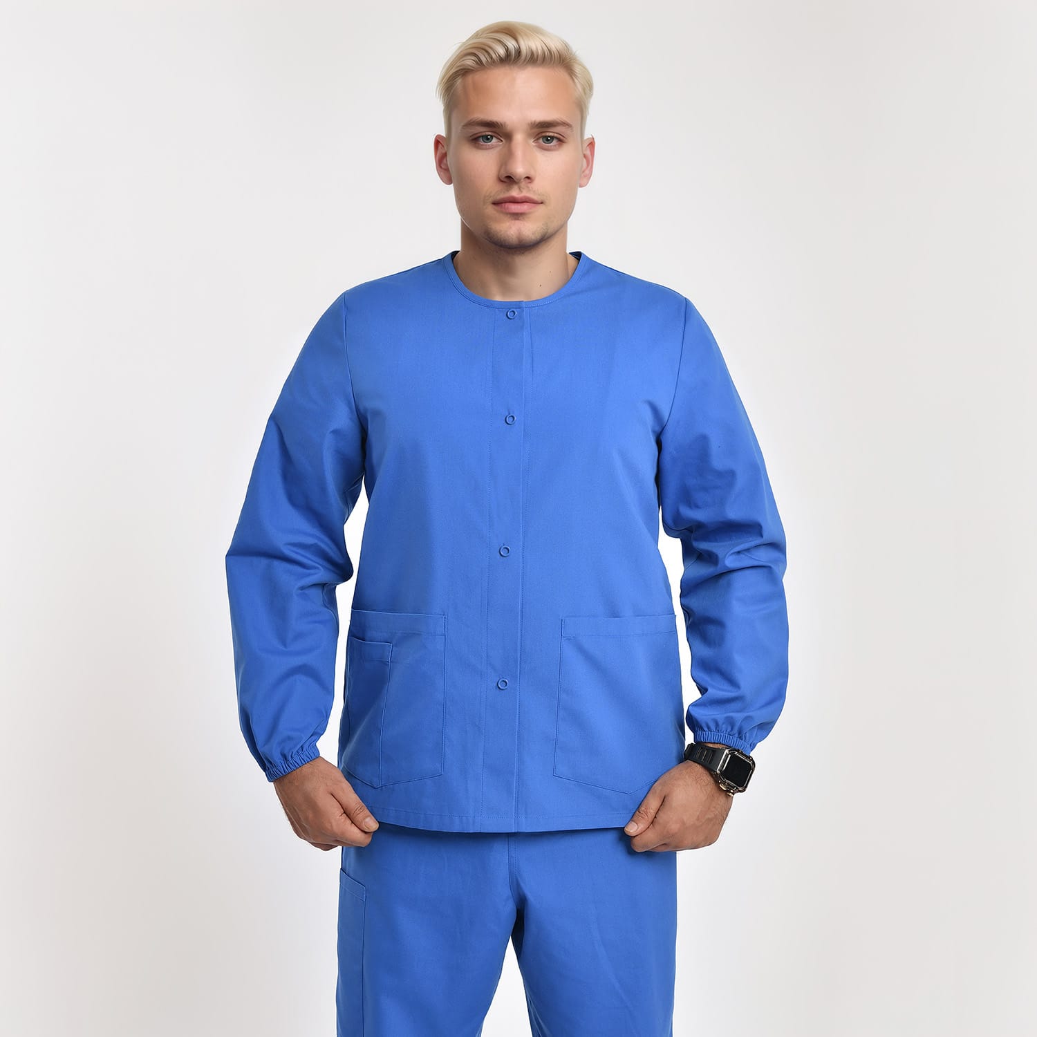 Front view of a model wearing a blue unisex 3-pocket warm-up scrub jacket with long sleeves, ideal for healthcare professionals.