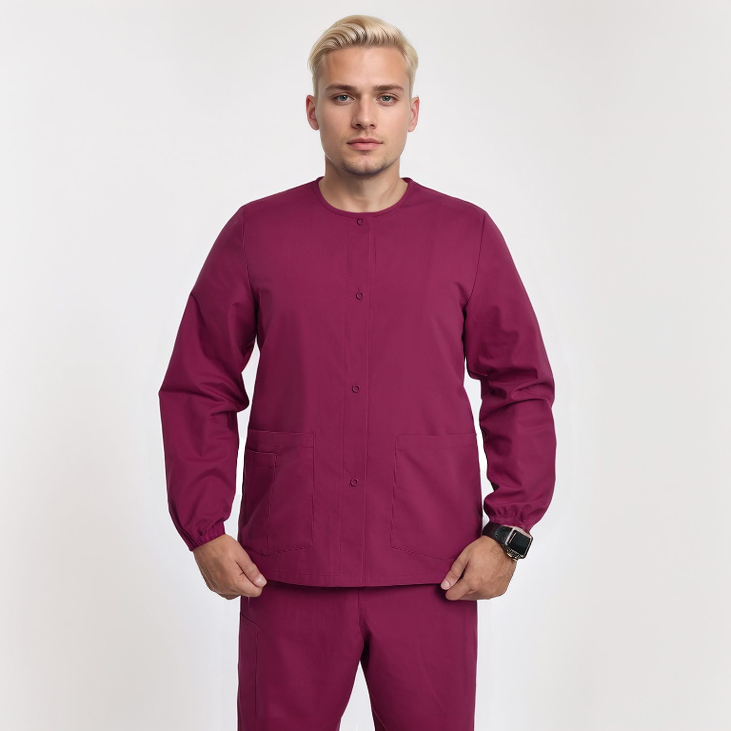Front view of a model wearing a burgundy unisex medical scrub jacket with long sleeves and button-down closure, designed for healthcare workers.