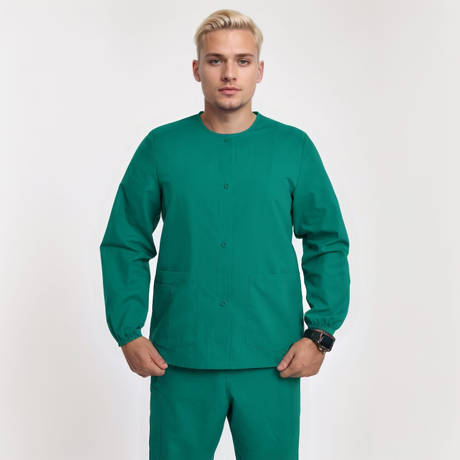 Front view of a model wearing a green unisex 3-pocket warm-up scrub jacket with long sleeves, ideal for healthcare workers.