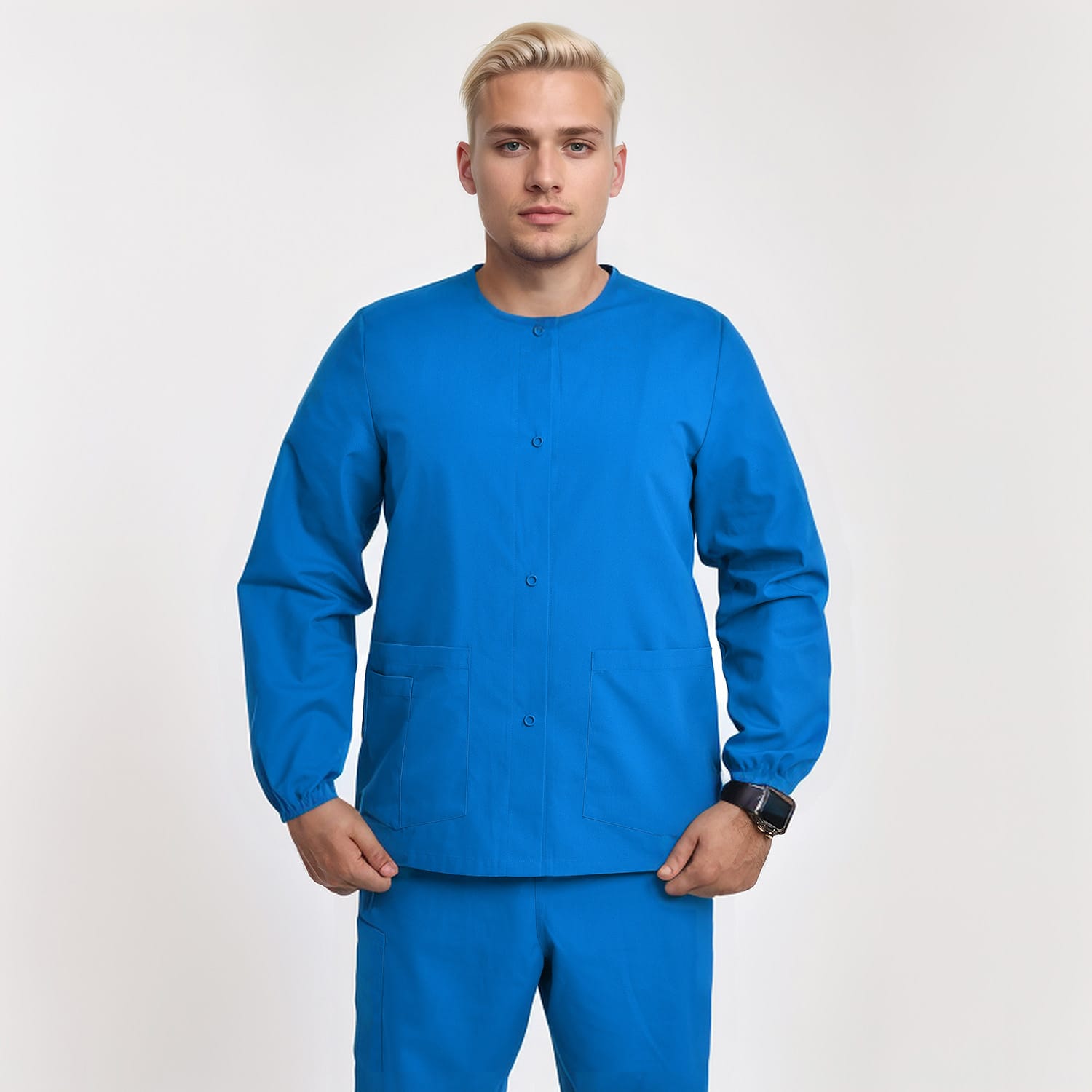 Front view of a model wearing a blue unisex 3-pocket warm-up scrub jacket with long sleeves, designed for healthcare workers.