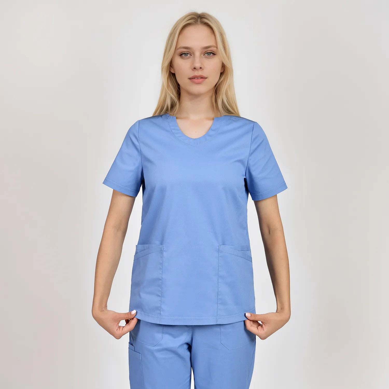 Side view of a women's blue scrub top with U-neck, designed for comfort and practicality in medical environments.