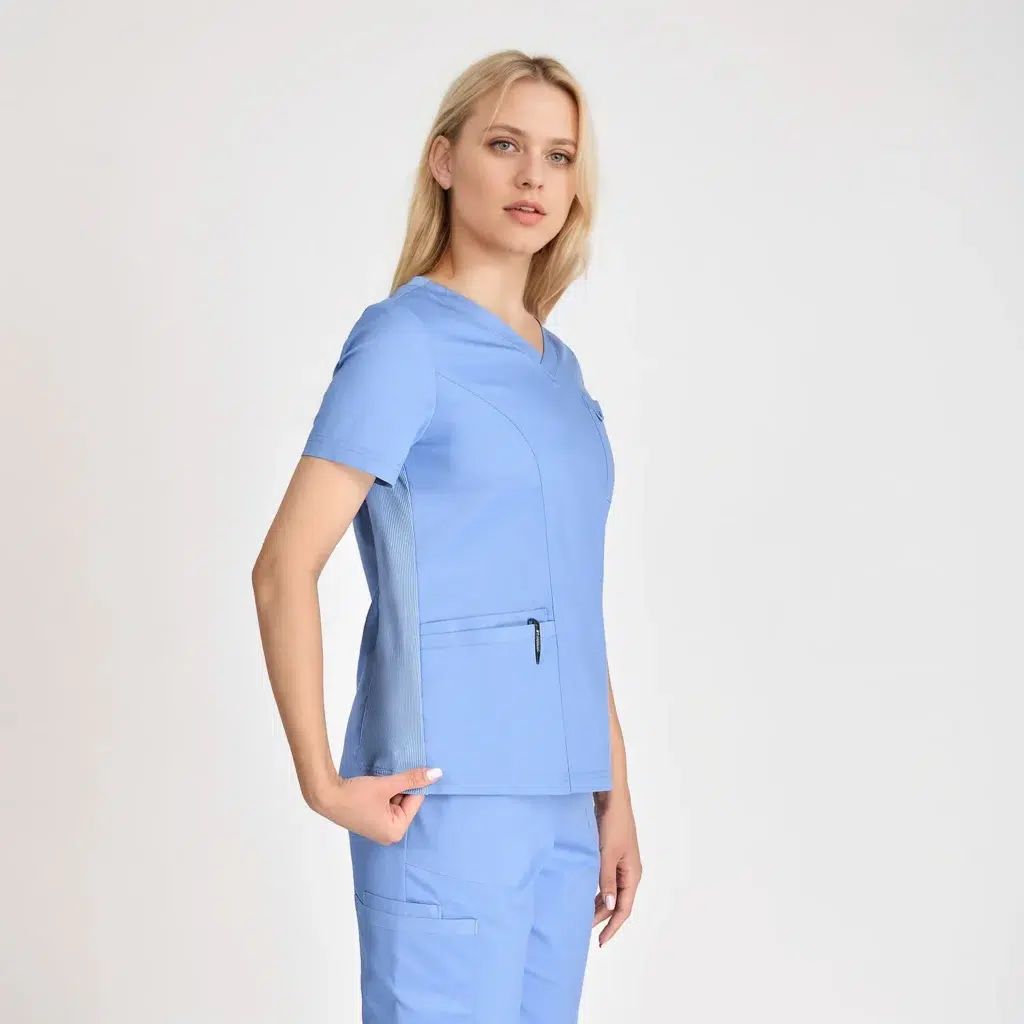 Close-up of a women’s V-neck scrub top in blue with side pockets and breathable fabric. Stylish and comfortable, perfect for medical work environments.
