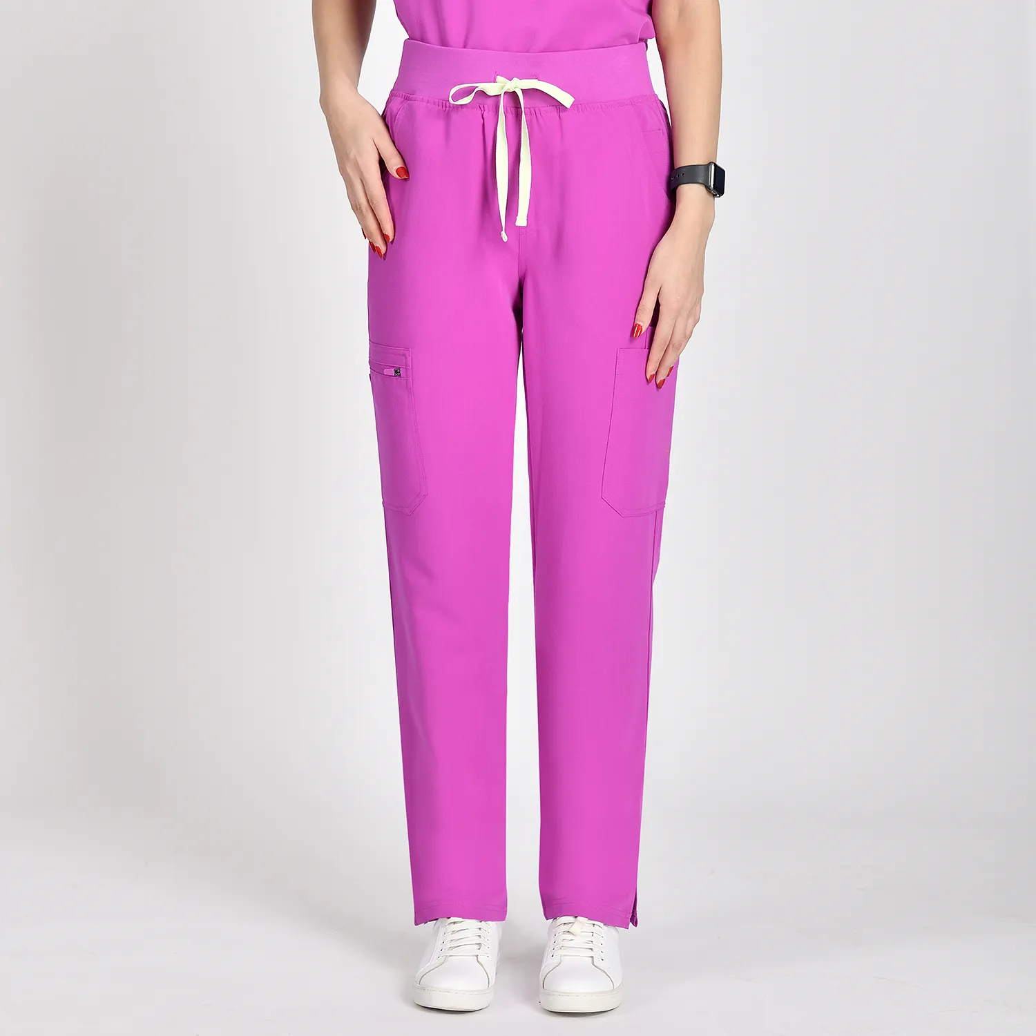 Close-up of pink medical scrub pants for women featuring a drawstring waist, loose fit, and six pockets, designed for comfort and style in medical settings.