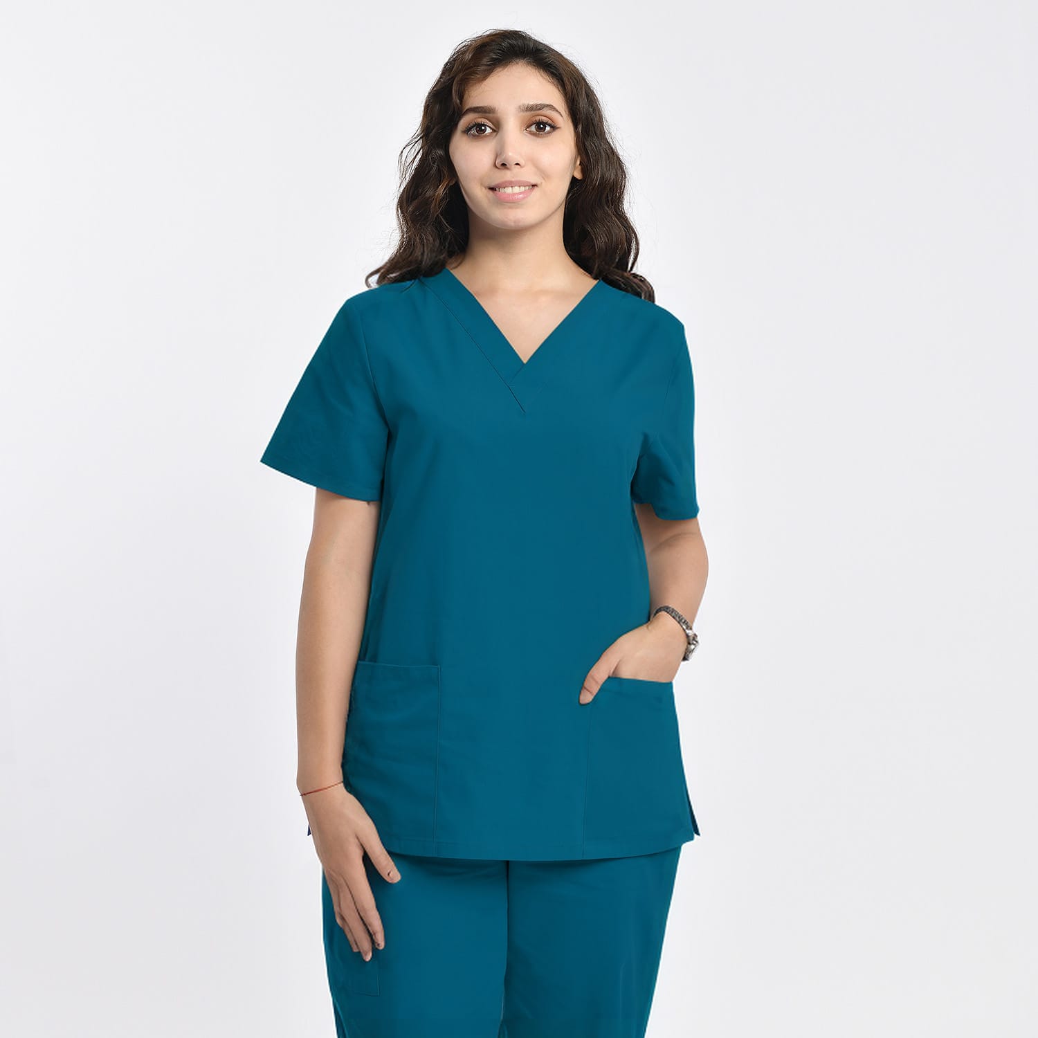 Front view of a model wearing a teal women’s 2-pocket V-neck scrub top, ideal for healthcare workers.